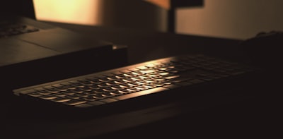 a computer keyboard sitting on top of a desk