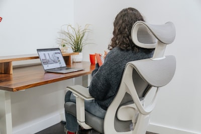 a woman sitting at a desk with a laptop